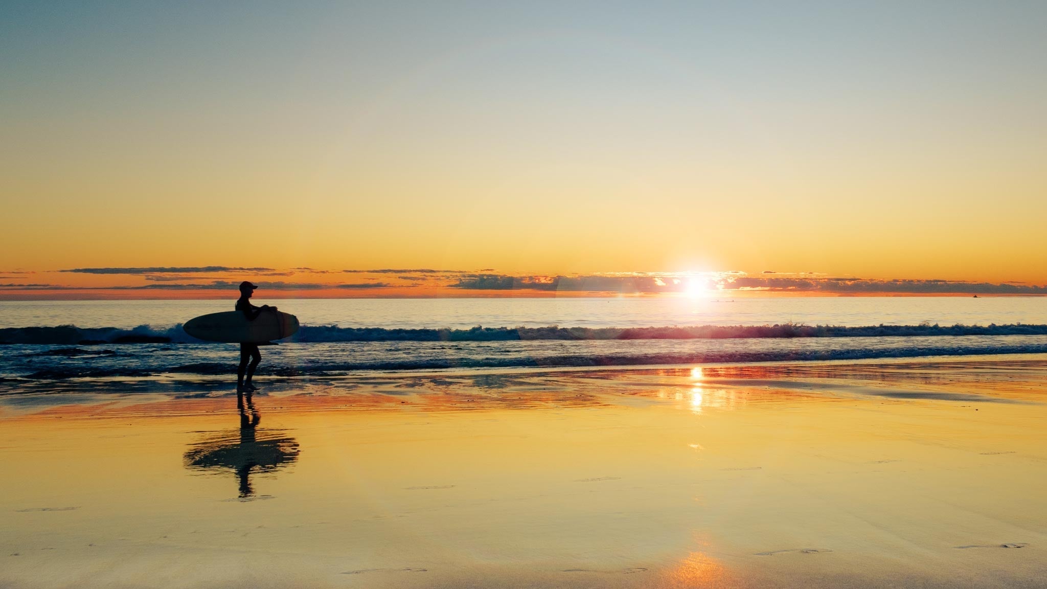 Image of surfer at sunrise